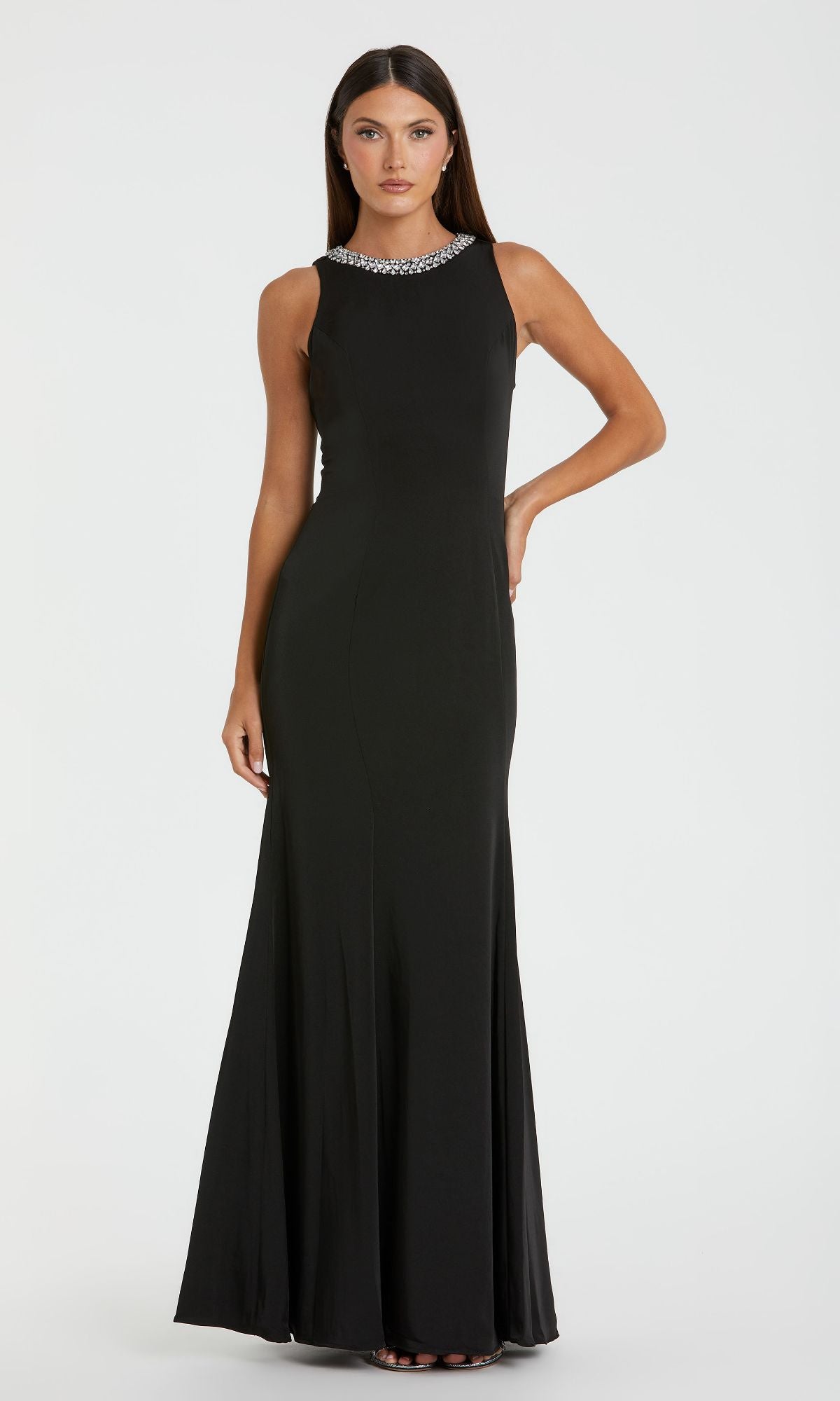 A woman wearing the Mac Duggal 49093 Beaded-Neck Long Prom Dress in black stands against a plain white background.